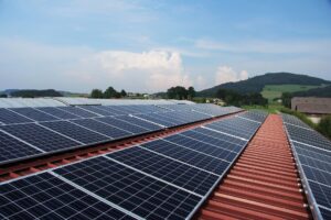 Wide field of solar panels under bright daylight, generating renewable energy through an efficient solar system with professional solar installations.
